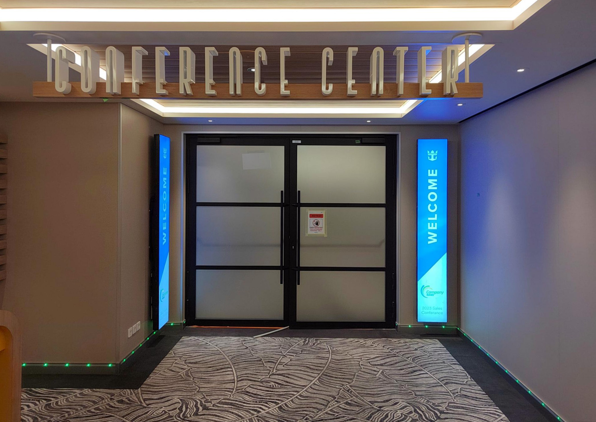 Main entrance to the conference center on board Royal Caribbean's Star of the Seas, featuring Tarvasovi-supplied aluminum-framed, B-15 rated full-glass doors with decorative grid patterns and handles. The double-leaf doors have a matte black textured finish and integrated panic function. Door dimensions: 2630 x 2200 mm.